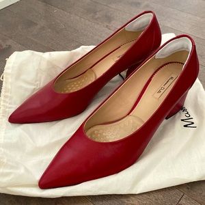 Genuine leather pumps with a block heel in rich red color.